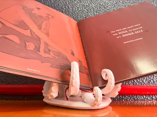 Open book with decorative stand on a textured surface